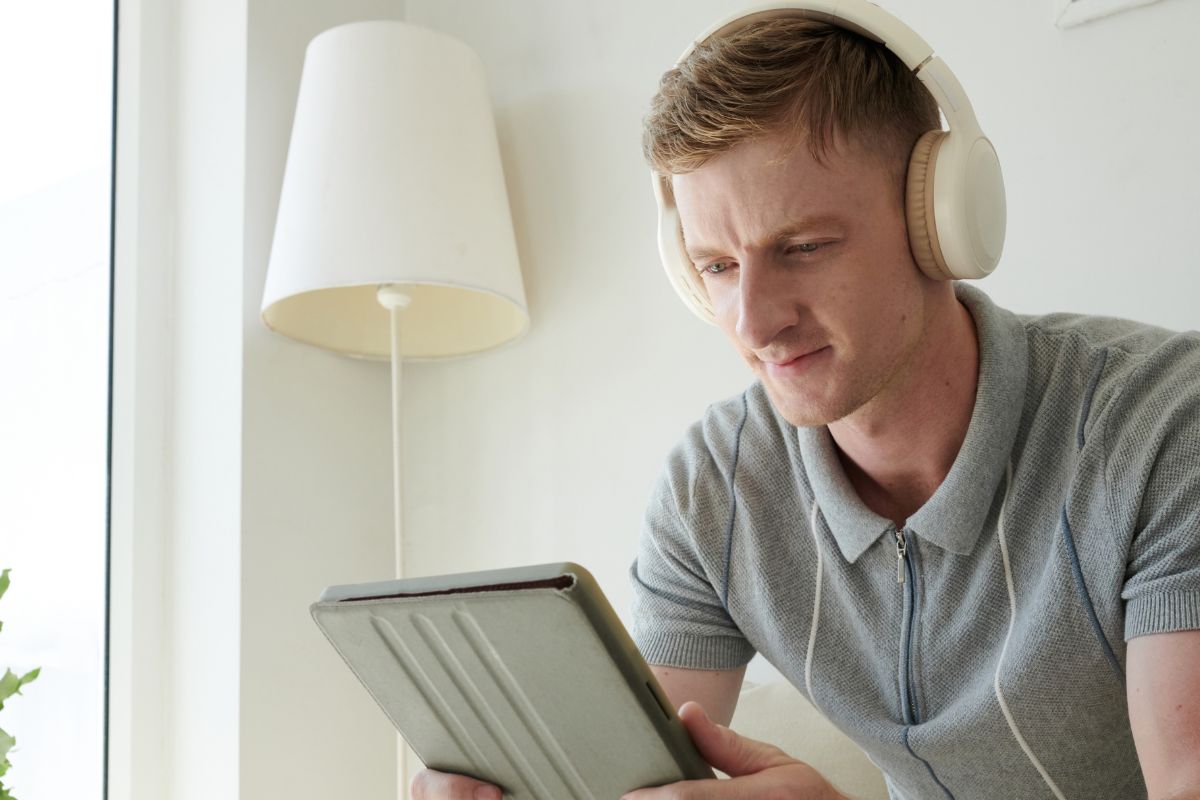 A picture of someone watching from his tablet.