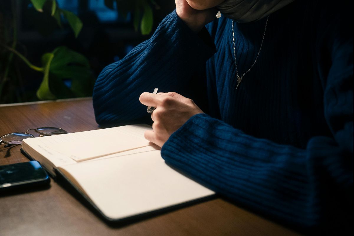 A picture of someone reading their notebook.