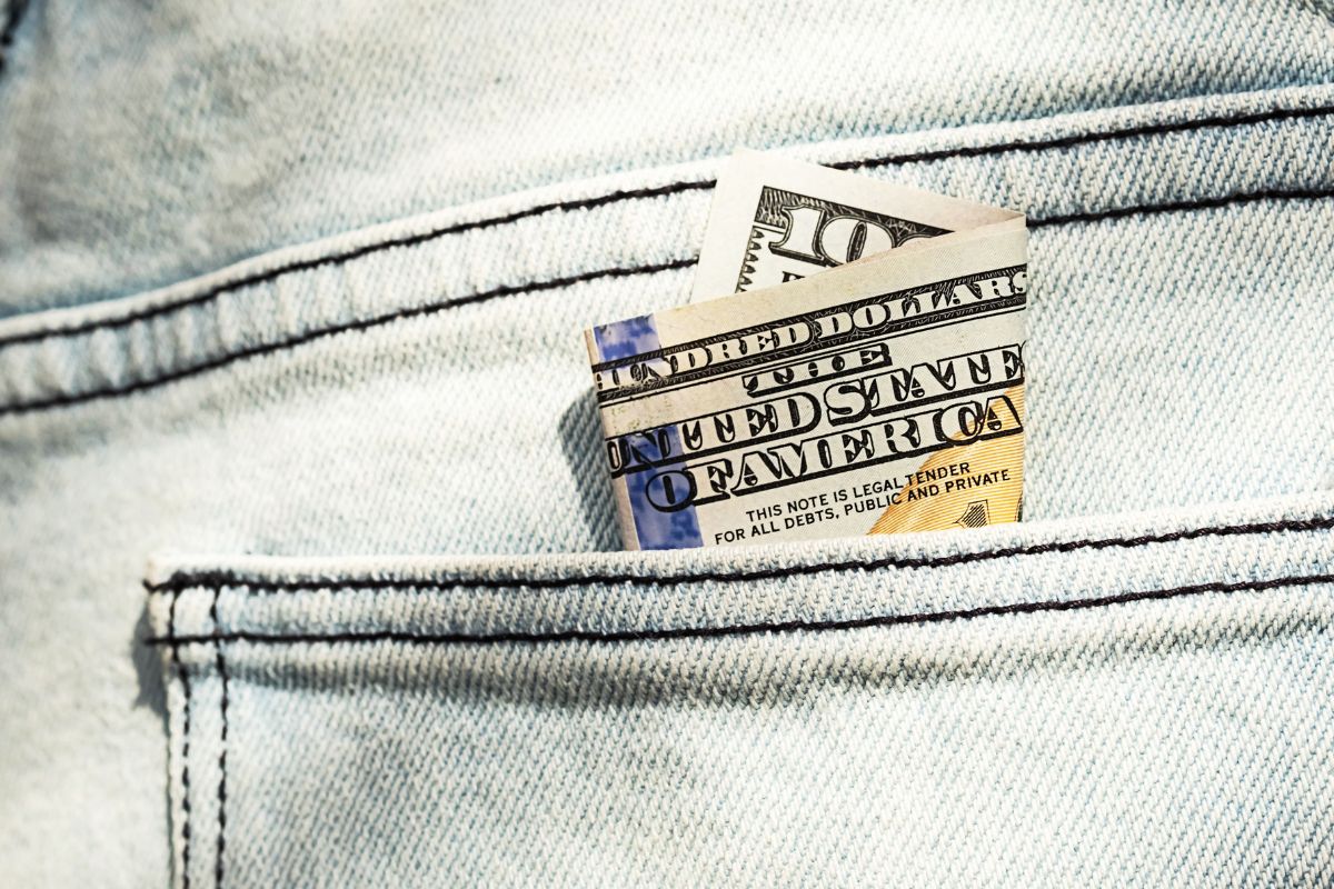 A picture of a $100 bill in a pocket.