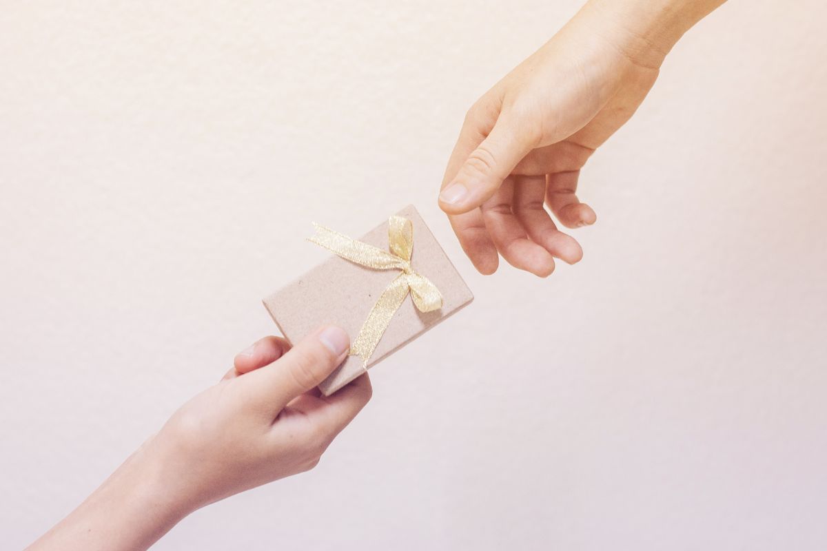 A picture of someone giving a gift.