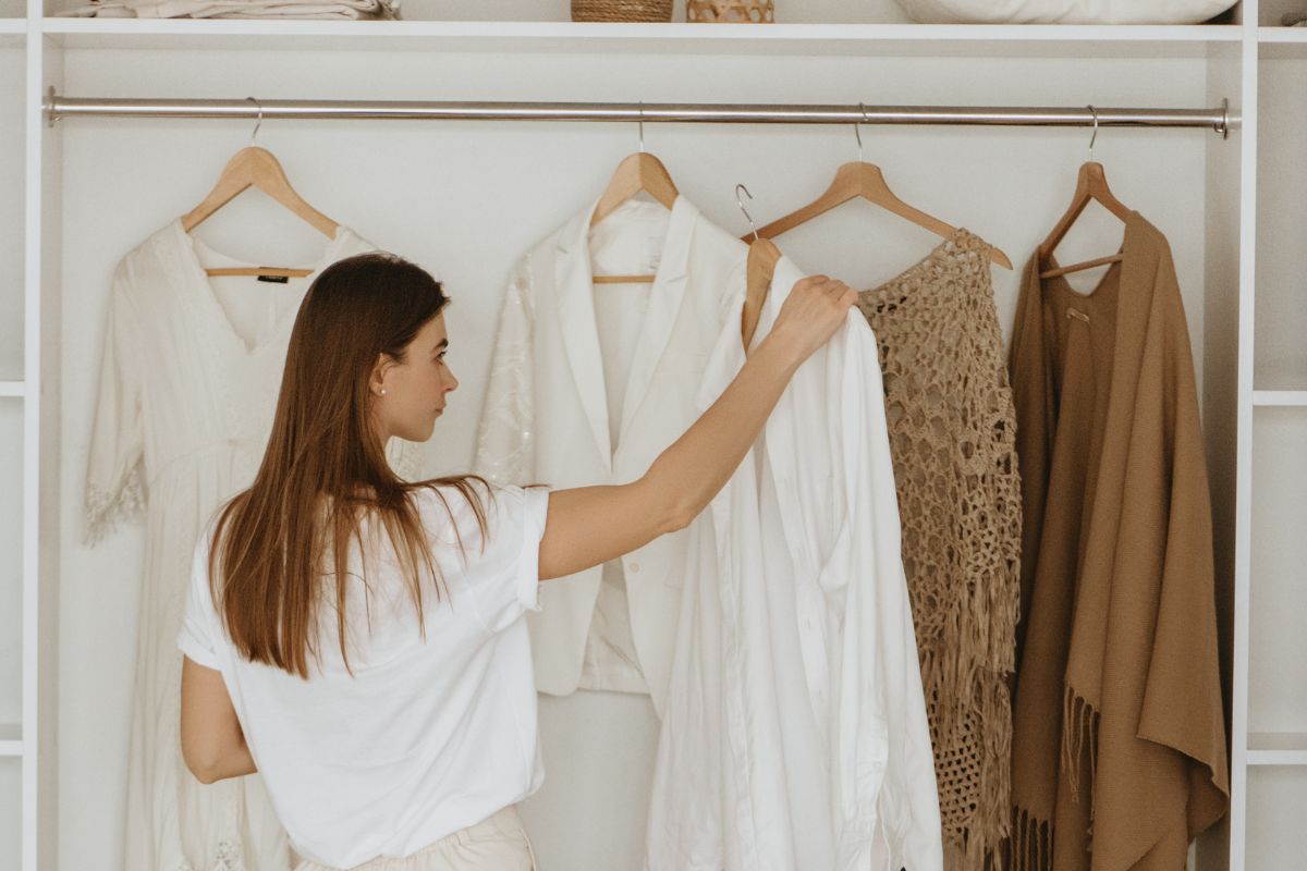 A picture of someone looking for clothes to sell.