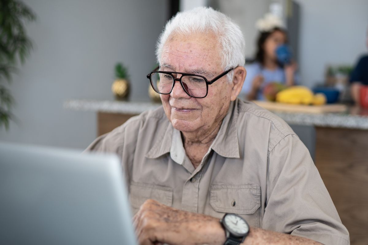 A picture of an elderly person using their laptop.