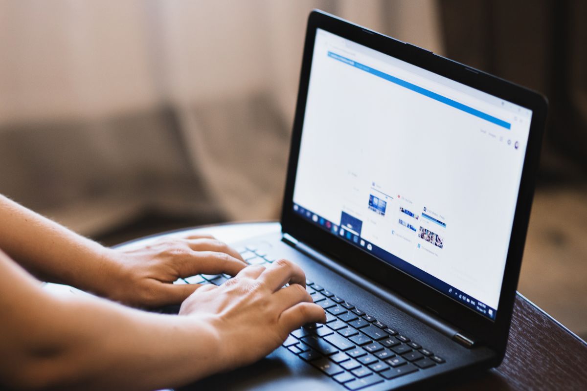 A picture of someone using laptop.