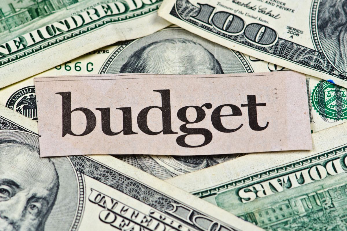 An image of money and paper with budget wording.