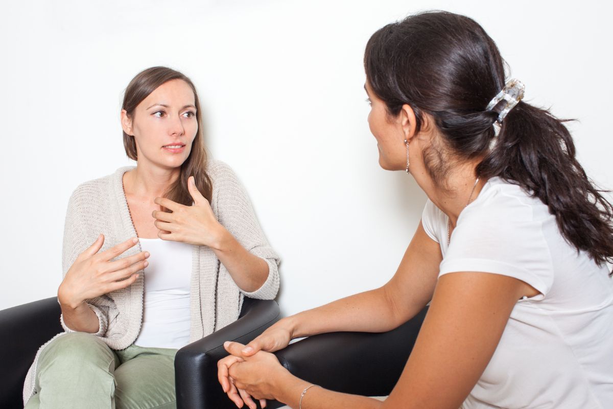 An image shows women talking together.