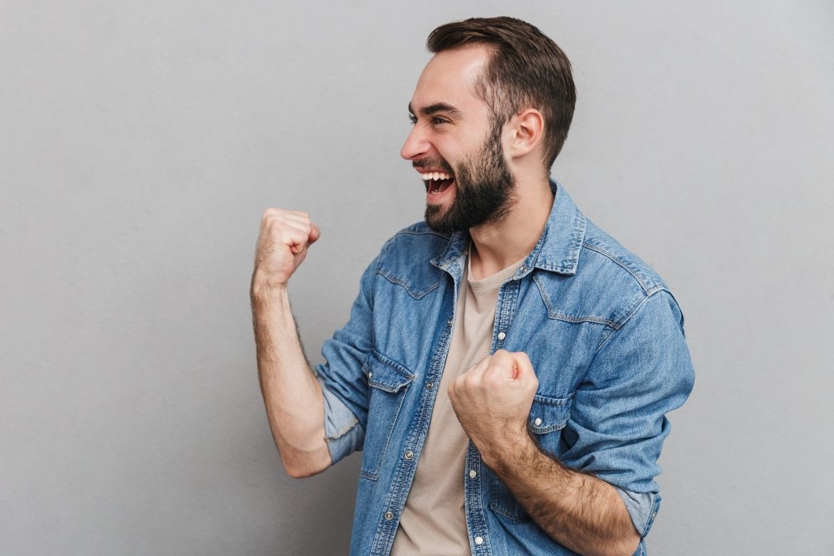 A picture of a happy man cheering.