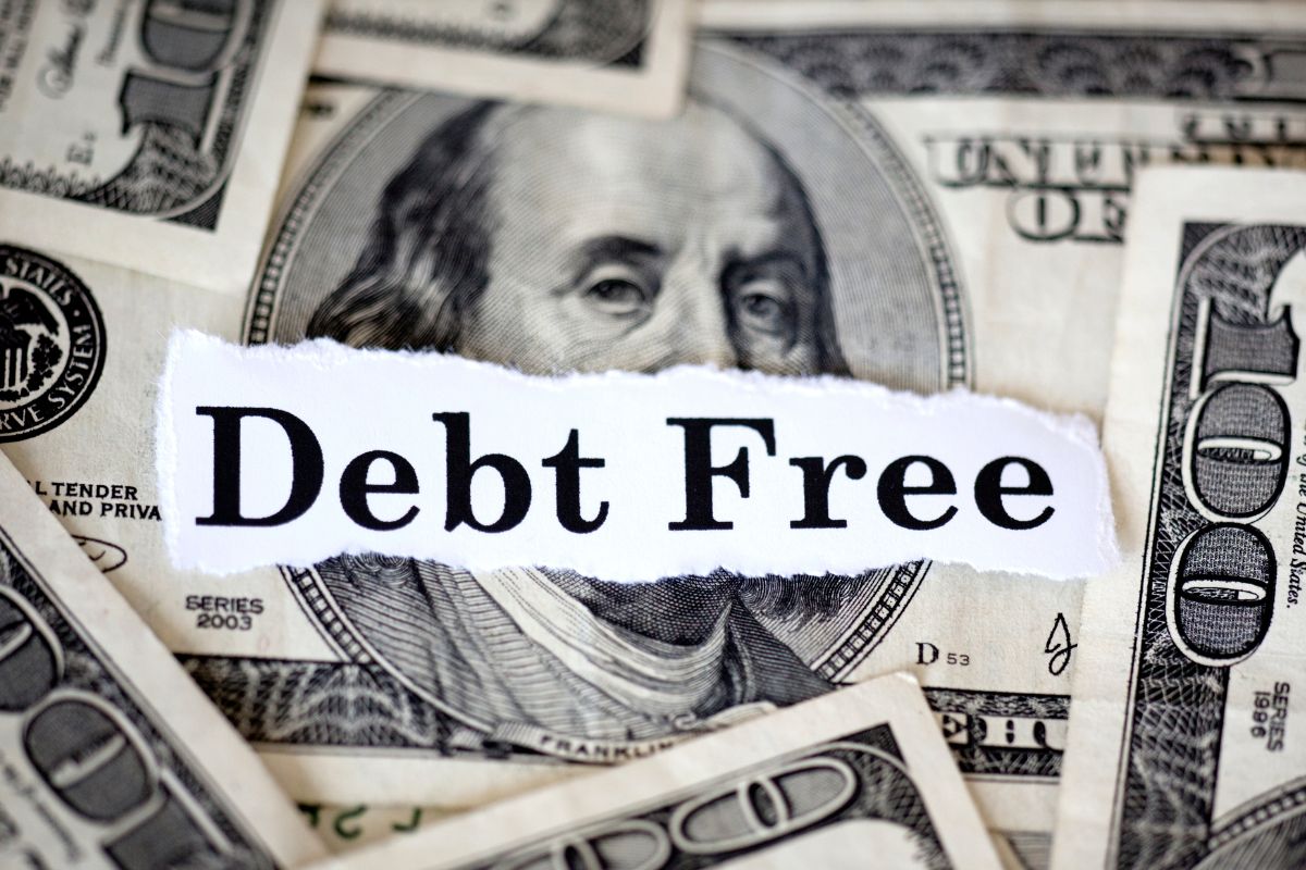 A picture of money and debt-free wording.