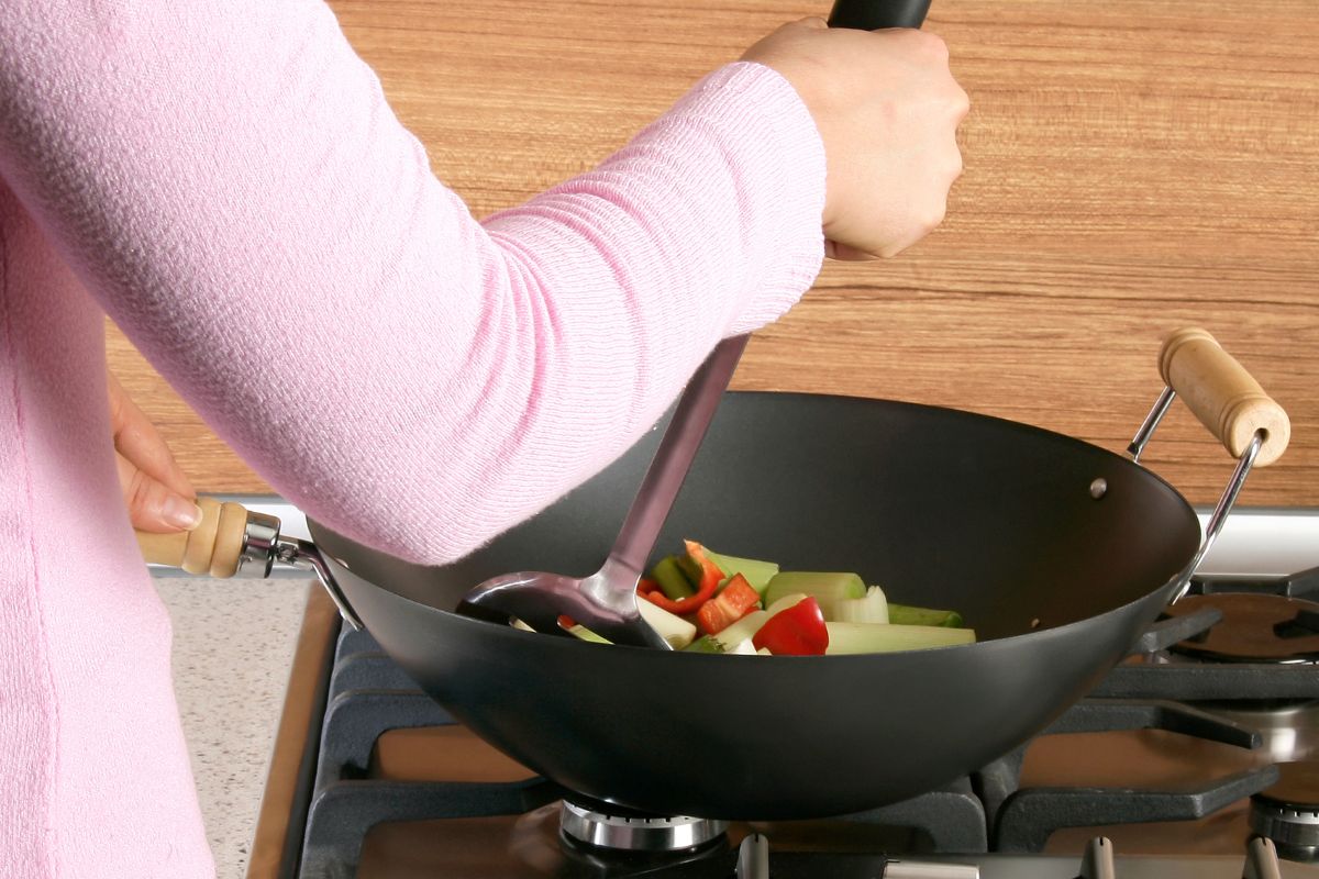 A picture shows a woman cooking a meal.