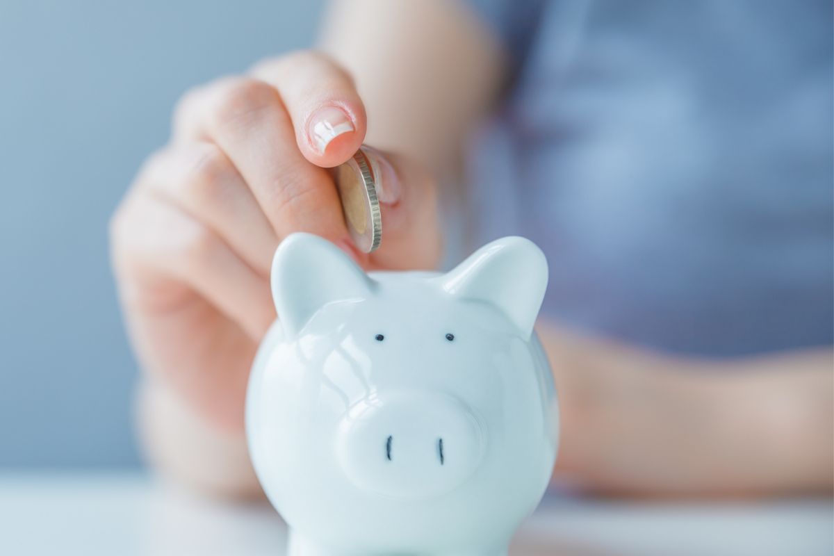 An image of a woman's hand saving money.