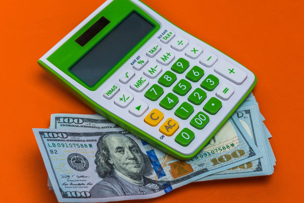 A picture of a calculator and money.