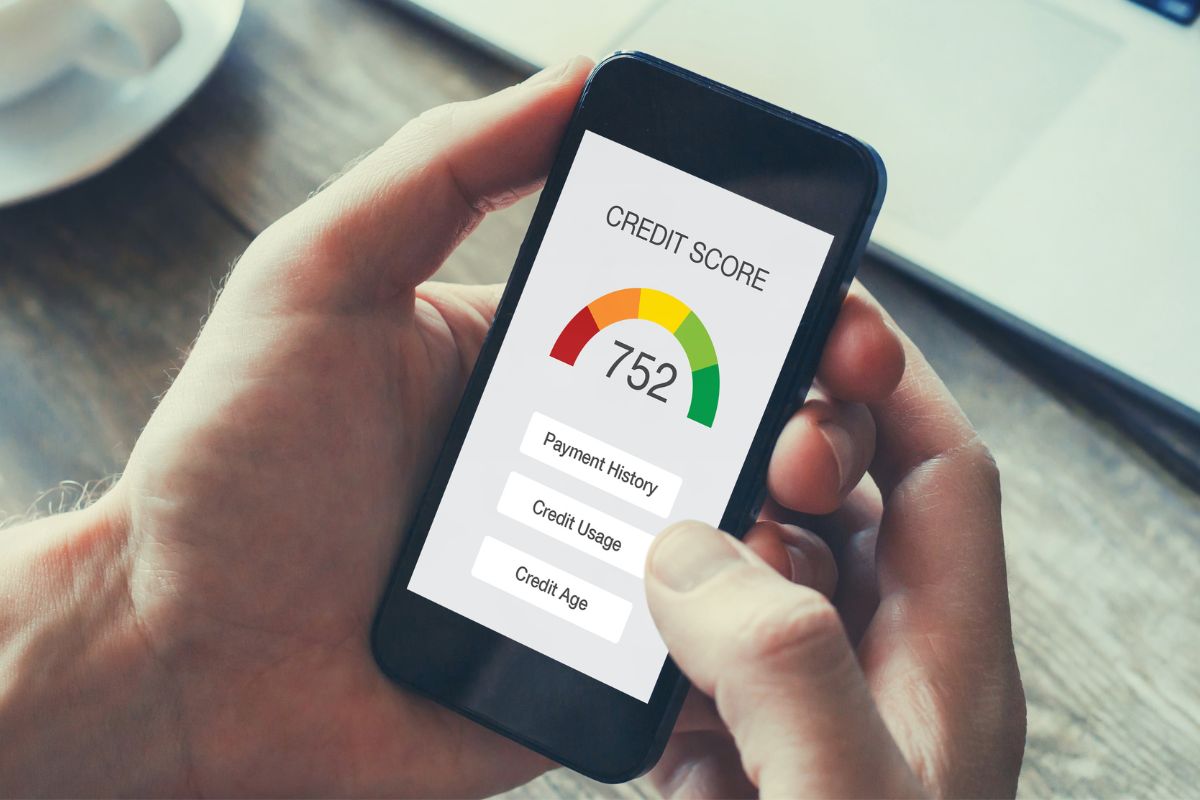 A picture shows a man's hand checking his credit score.