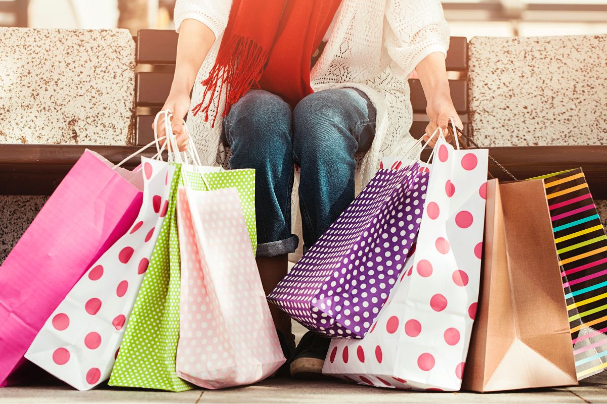 A picture shows a woman holding the shopping bags.
