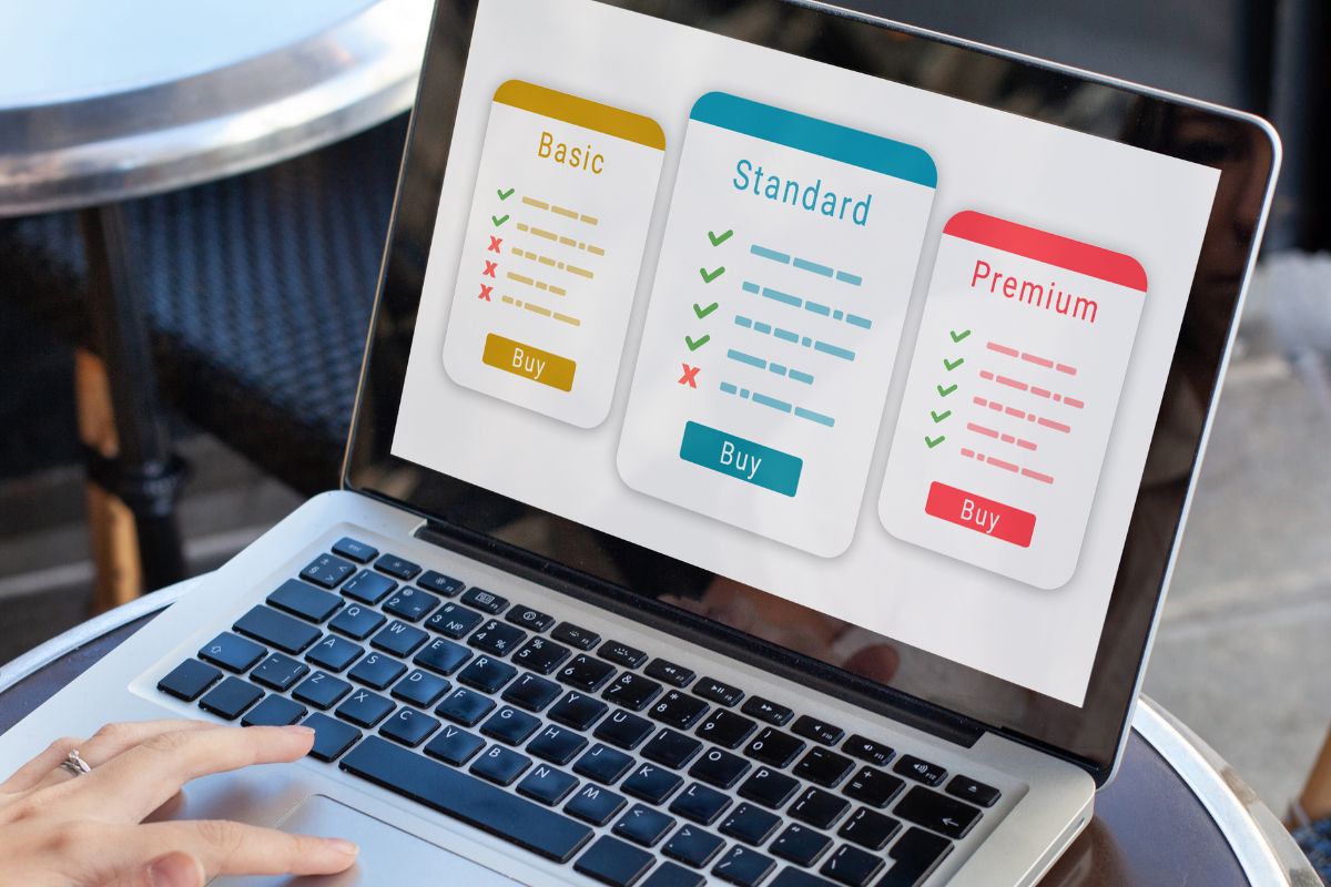 An image shows a woman's hand using a laptop.