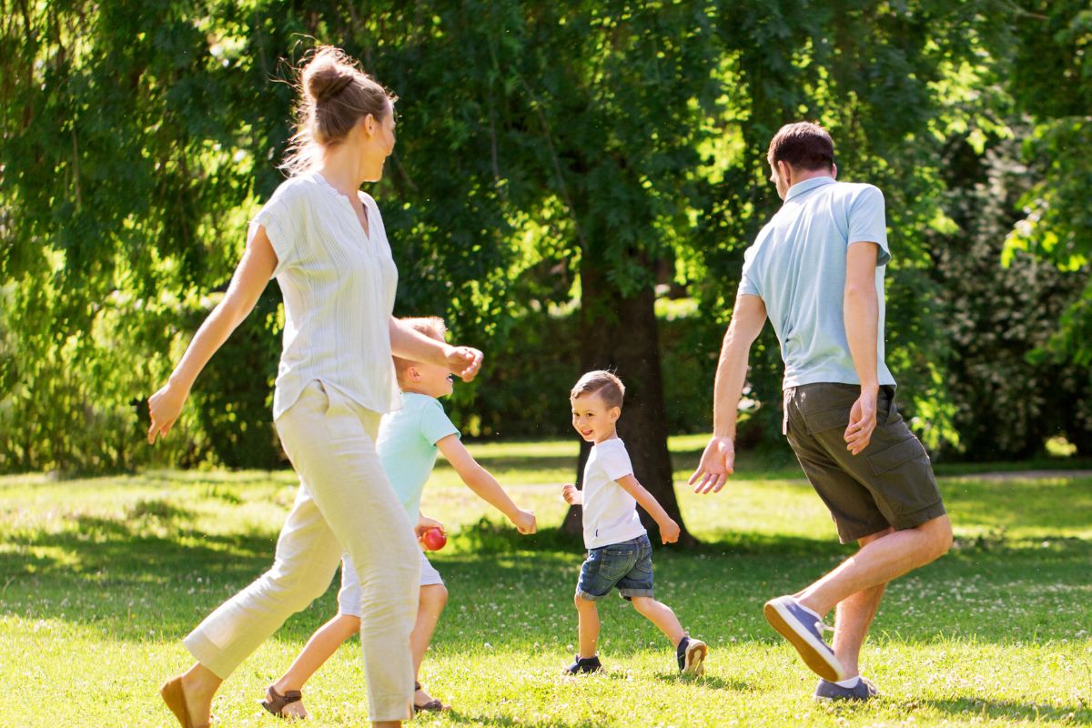 A picture of a family playing at the park.