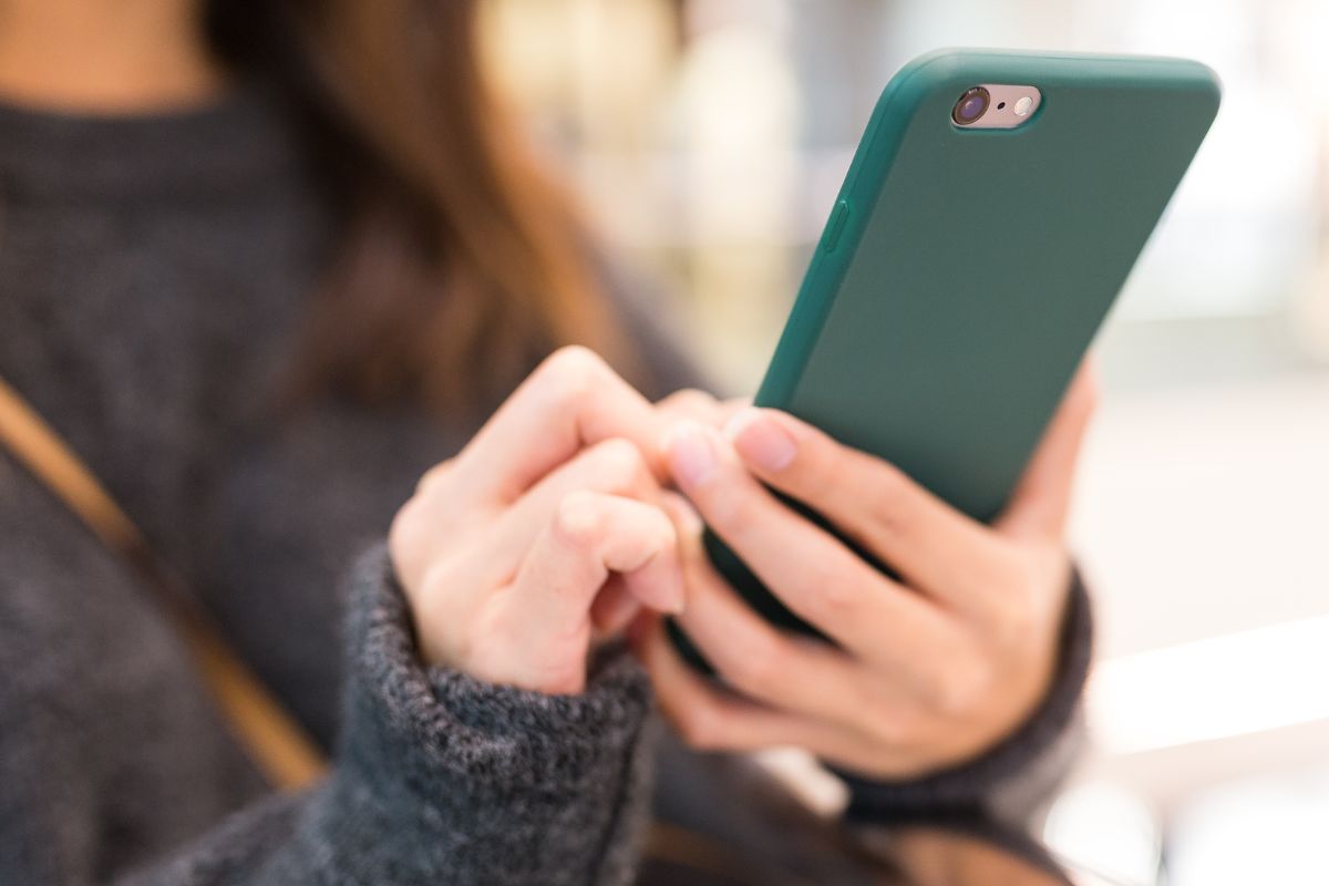 A picture of a woman using a phone.