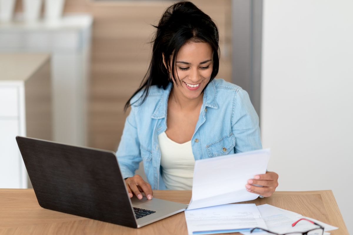 An image of a woman working on the papers.