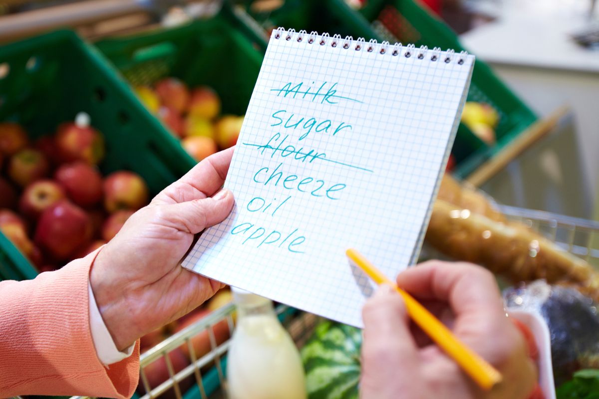 An image of a woman checking her shopping list.