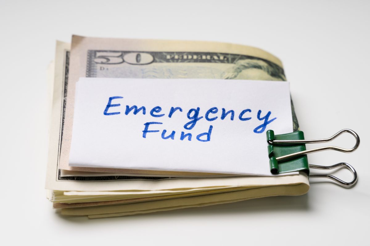 A picture of money with emergency fund wording.