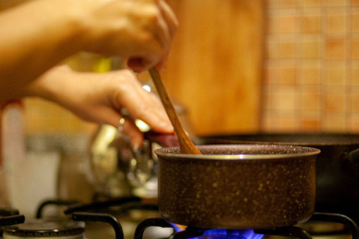 A picture of a woman cooking something.