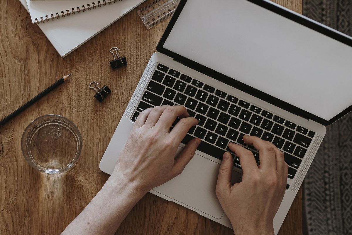 A picture shows a woman's hand using a laptop.
