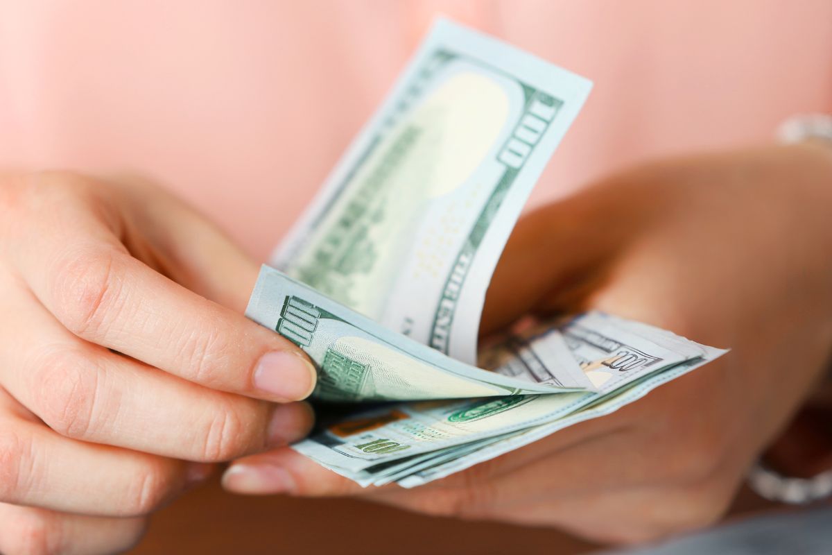 An image of a woman's hand counting money.