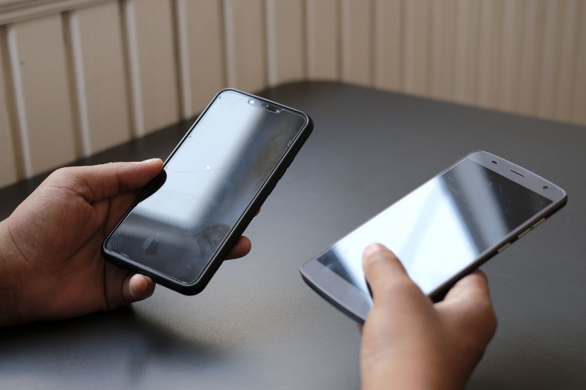 A picture shows a man holding two phones.