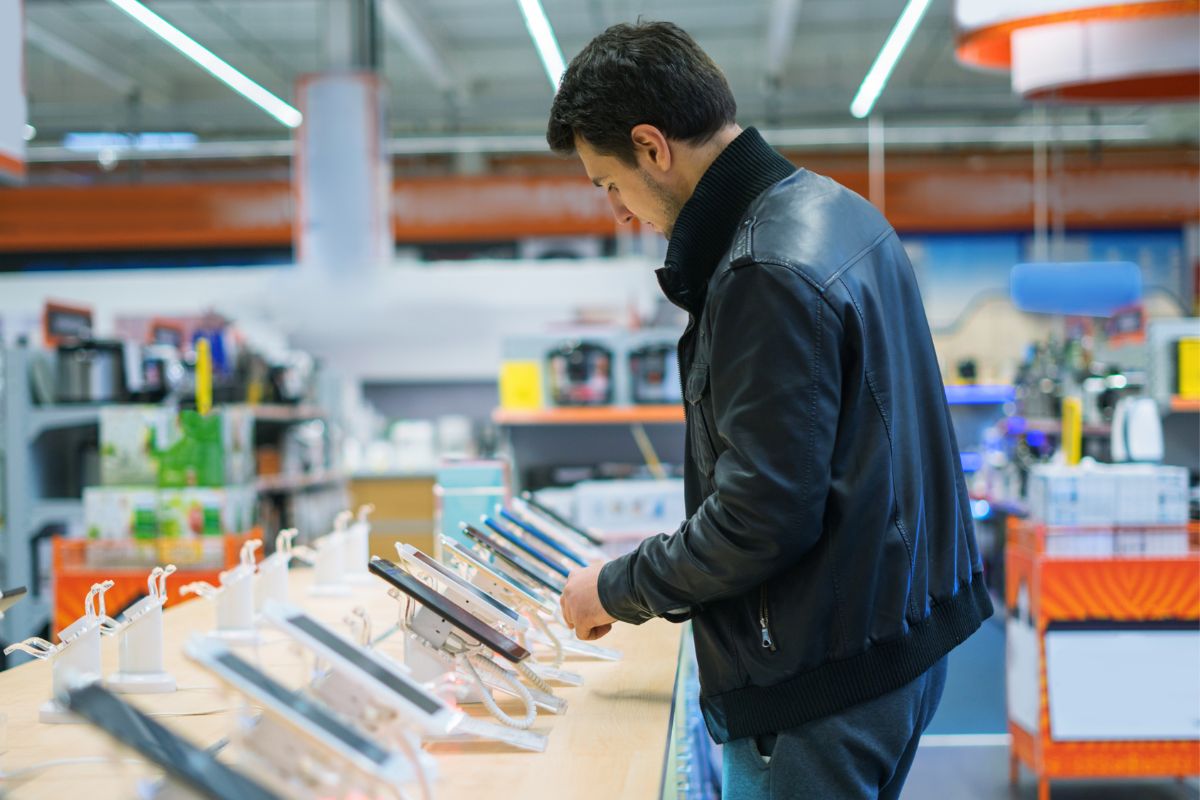 A picture of a man shopping for a new phone.