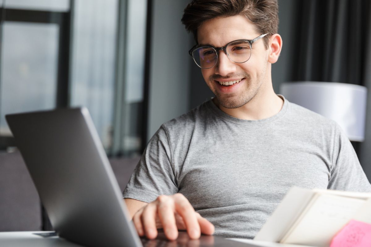 A picture shows a man working on his laptop.