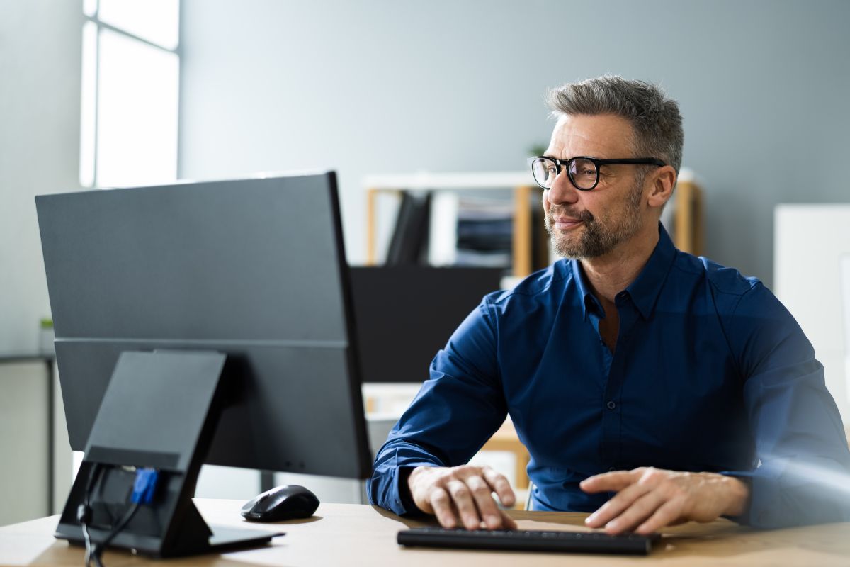 A picture of a man using a computer.