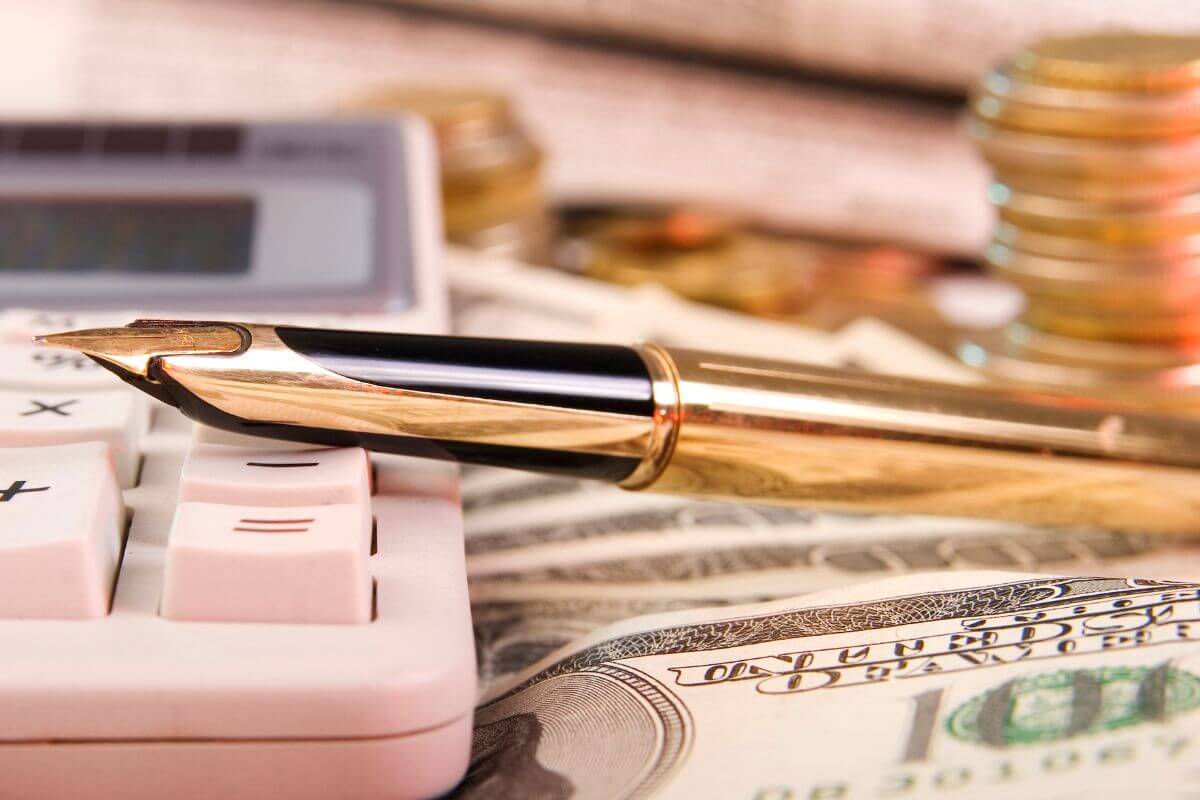 An image shows a calculator and money.