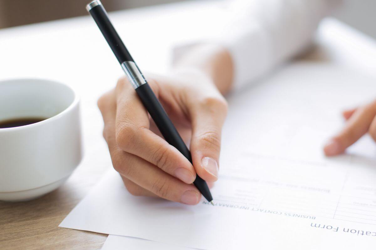 An image of a woman filling out a form.