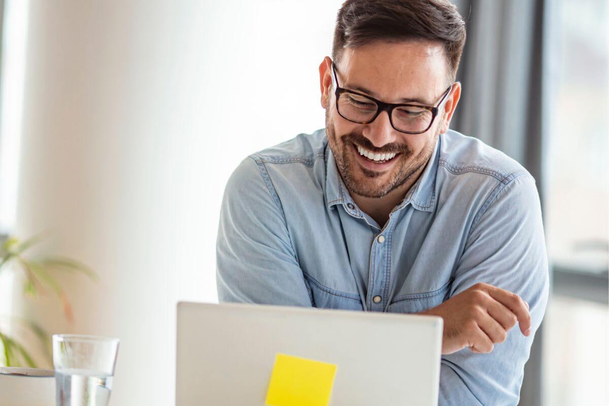 A picture shows a man using a laptop.