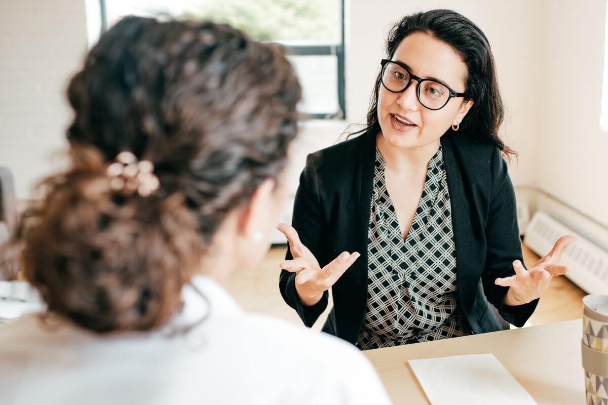 An image shows women talking to each other.