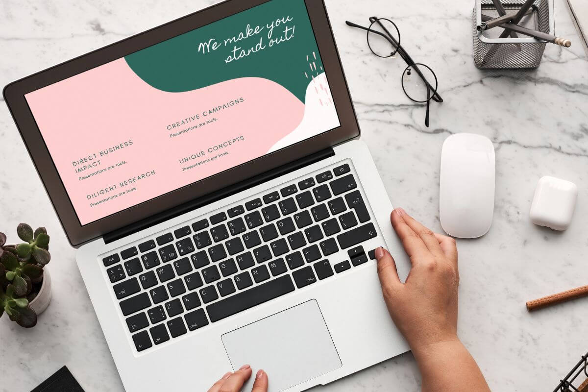 A picture of a woman's hand using a laptop.