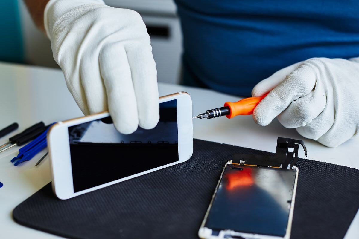 A picture shows a man fixing the phone.