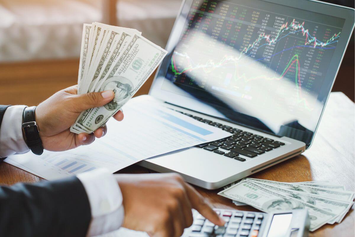 An image of a man calculating his money.