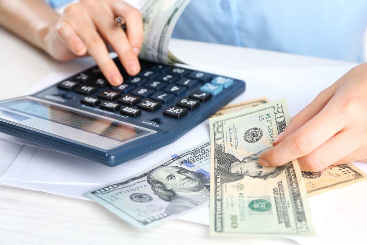 A picture shows a woman calculating money.