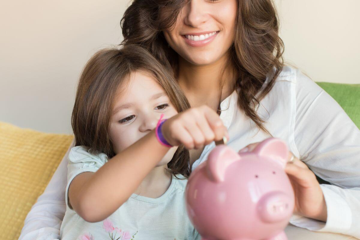 An image of a mother and her daughter saving money.