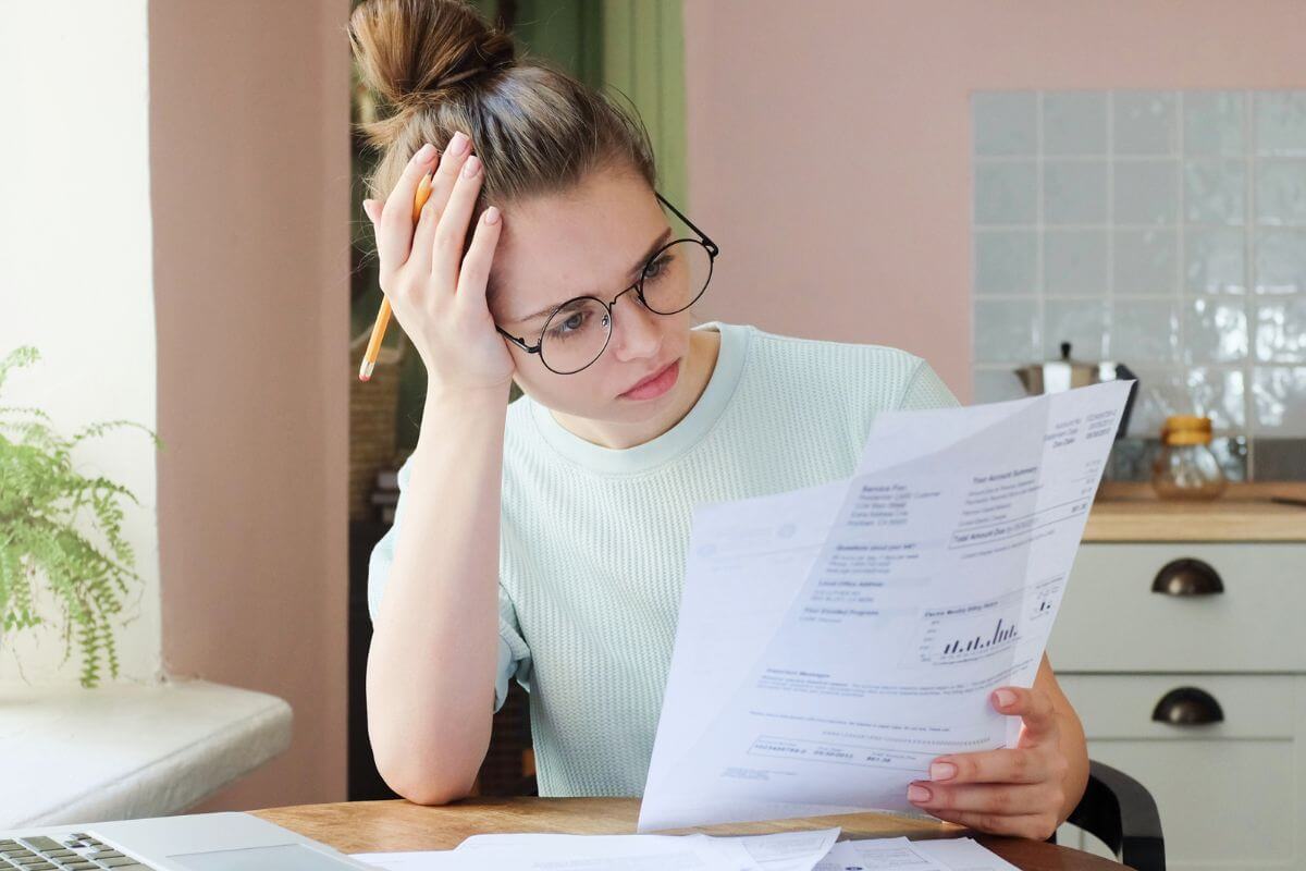 An image shows a woman reviewing papers.