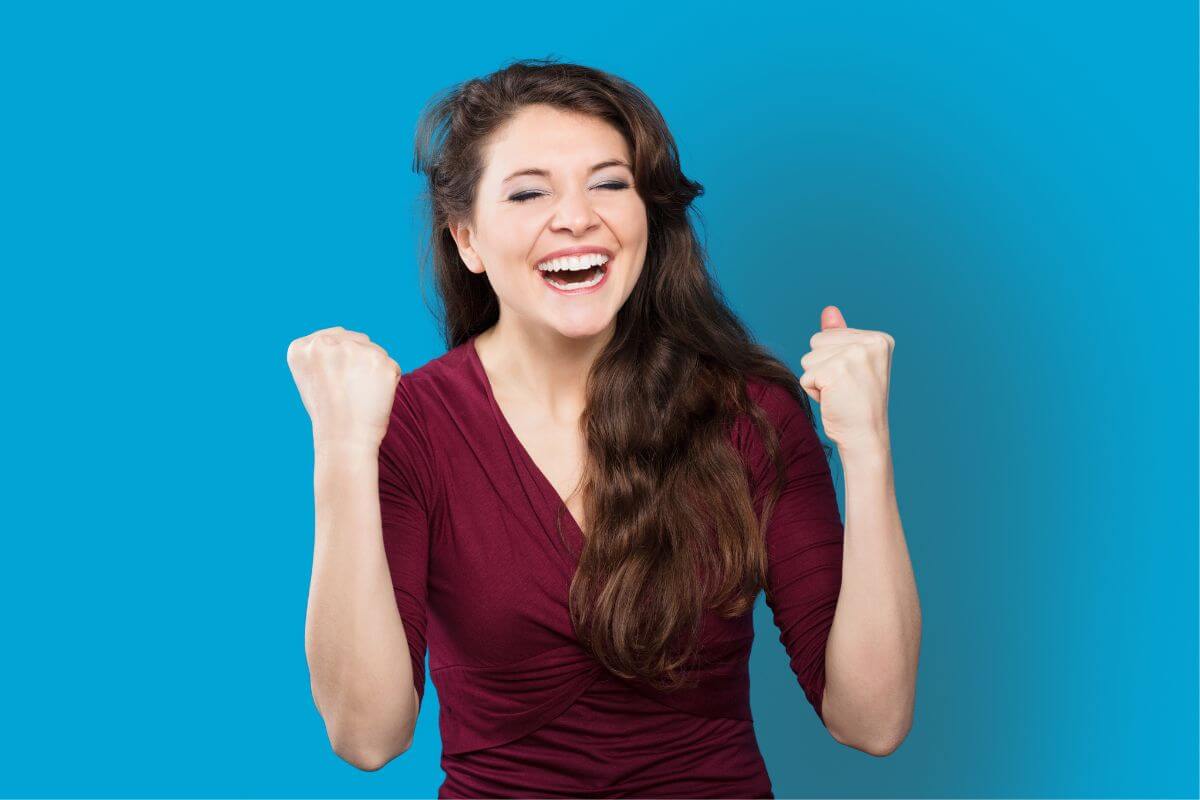 An image of a woman cheering in excitement.