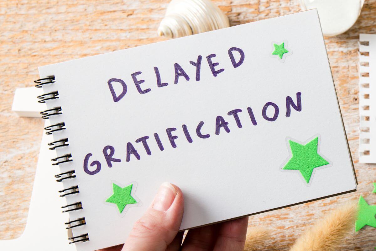 A photo of the hand of a woman with a notebook.