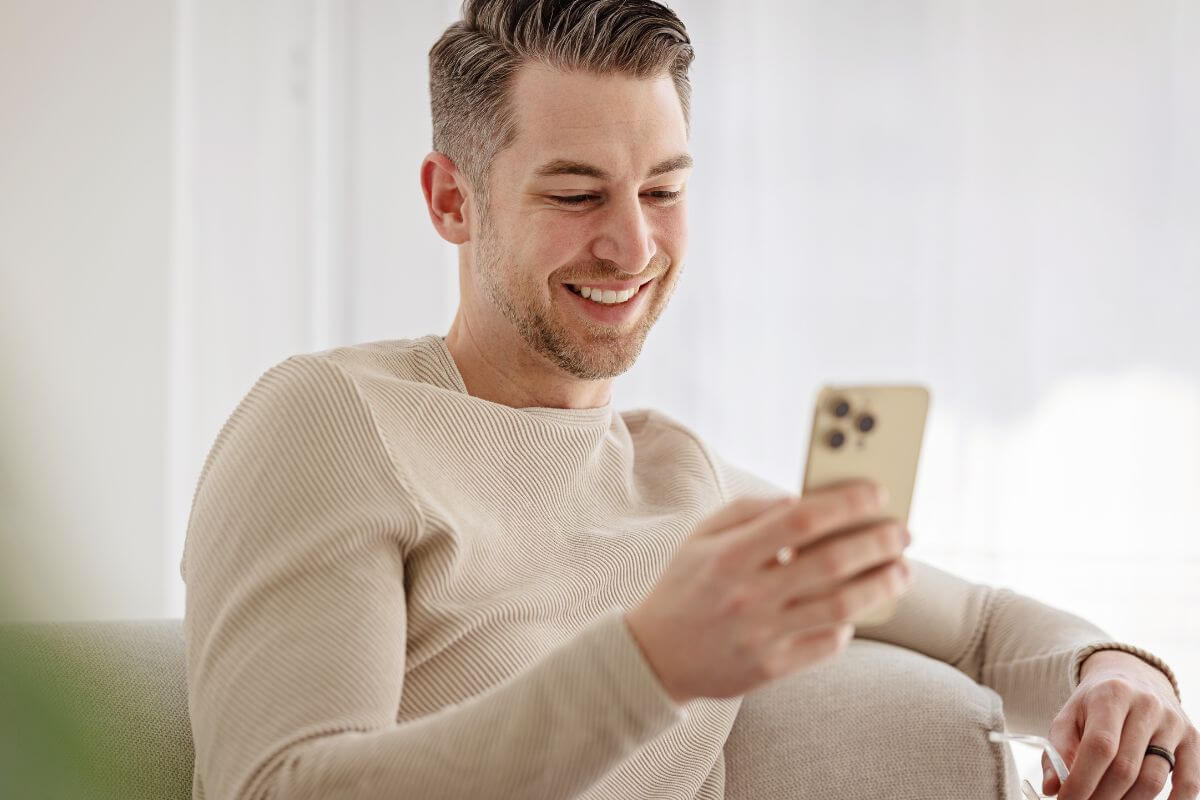 A picture shows a man using a phone.
