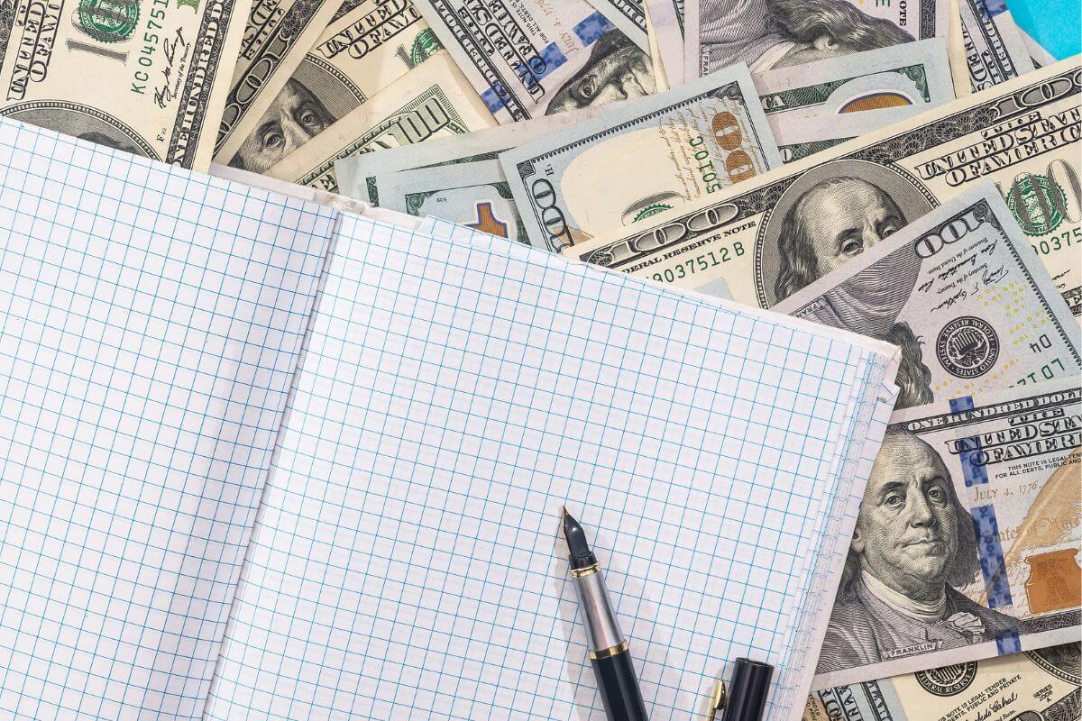 A picture of money and a notebook.