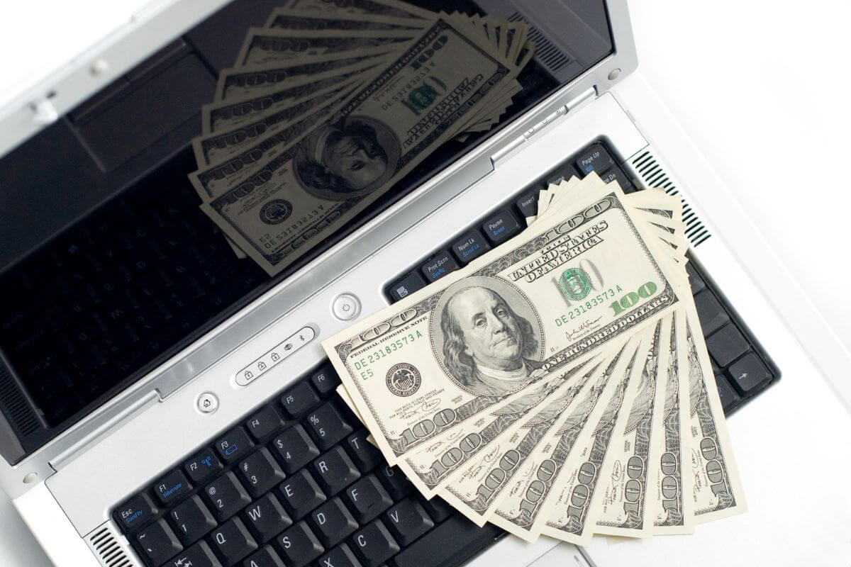 An image of a laptop and money.