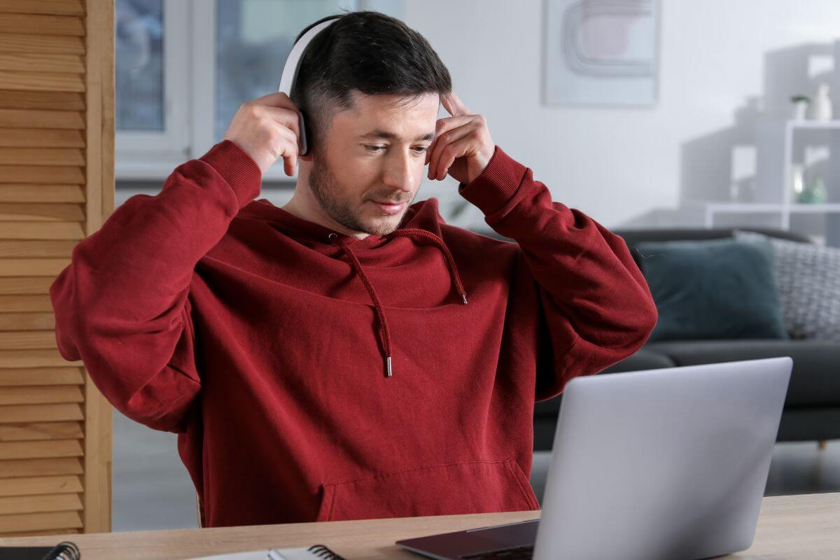 A picture of a man using a laptop.