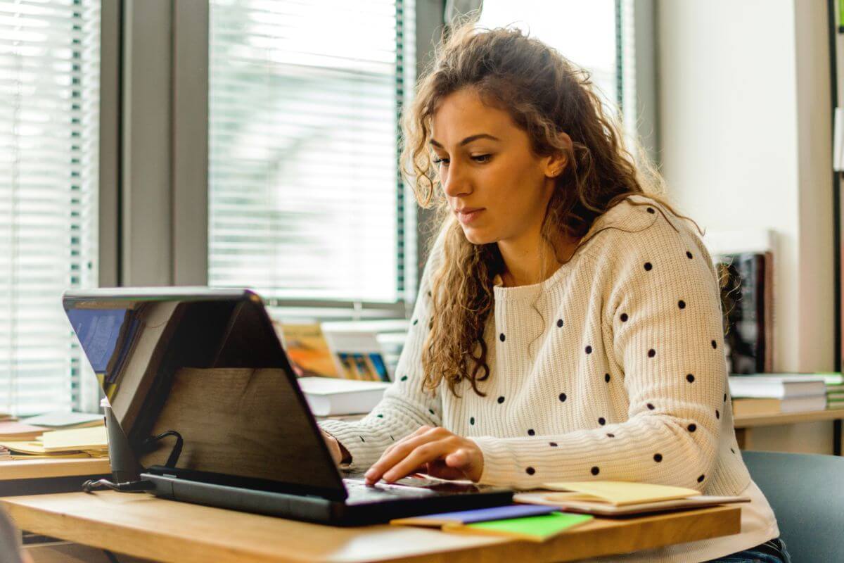 A picture of a woman using a laptop.