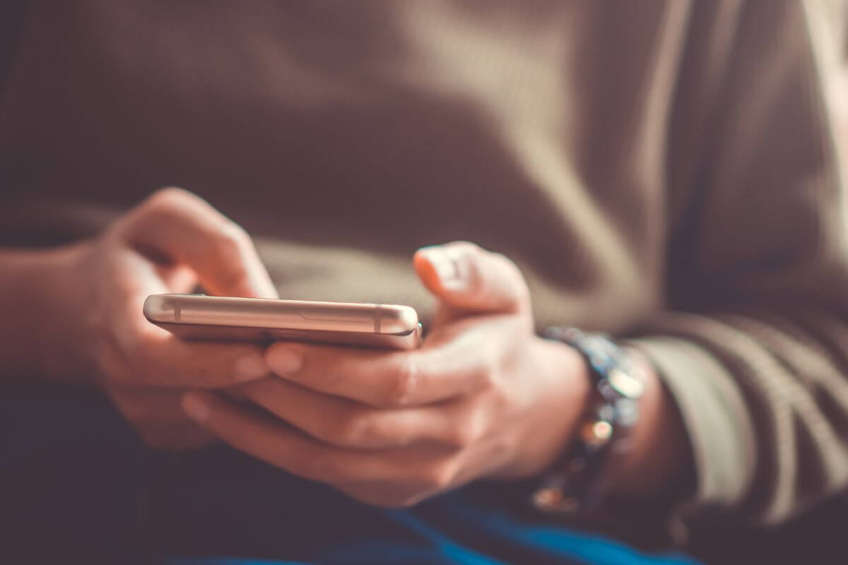 A picture of a woman using a phone.