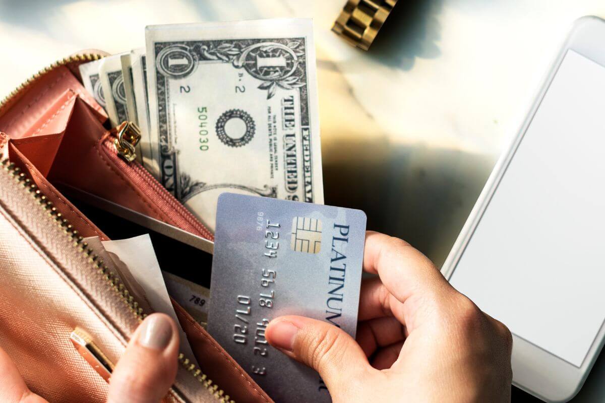 A picture of a woman's hand opening her wallet.