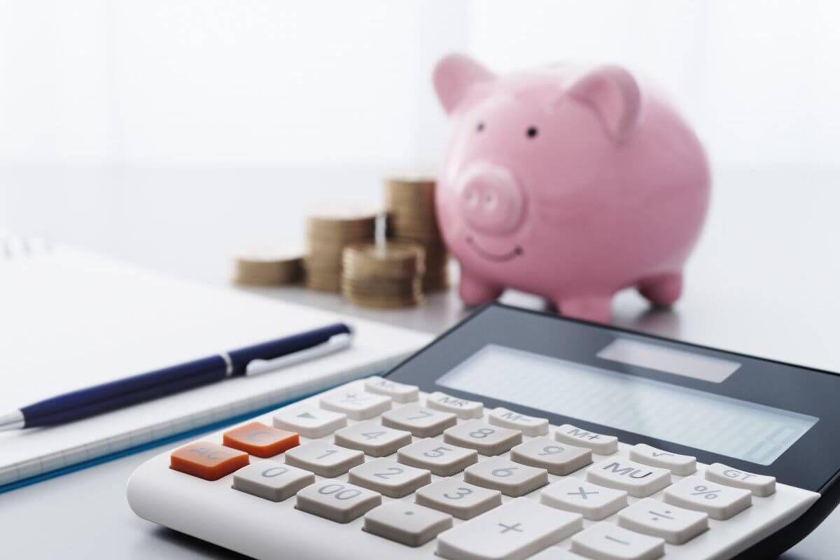 A picture of money savings and a calculator.