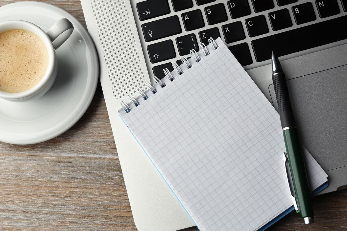A picture shows a laptop and a notebook.